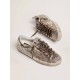 Super-Star sneakers in platinum-colored glitter with star and heel tab in tone-on-tone laminated leather Super-Star sneakers in platinum-colored glitter with star and heel tab in tone-on-tone laminated leather